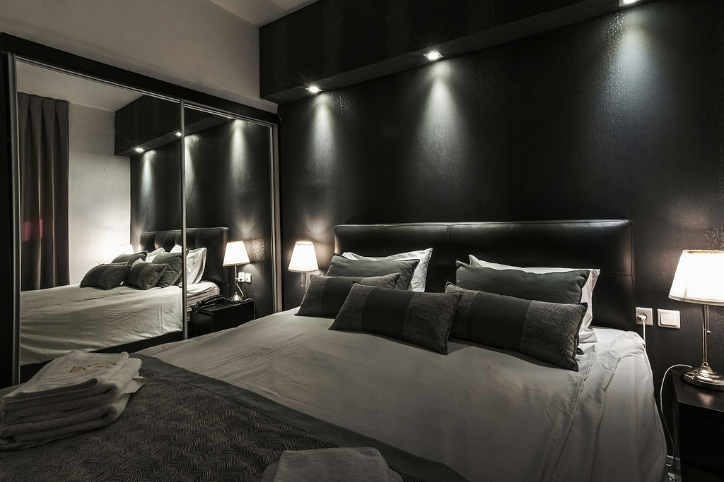 Chambre King avec armoire miroir reflétant l'éclairage à l'Hotel Kikar Netanya