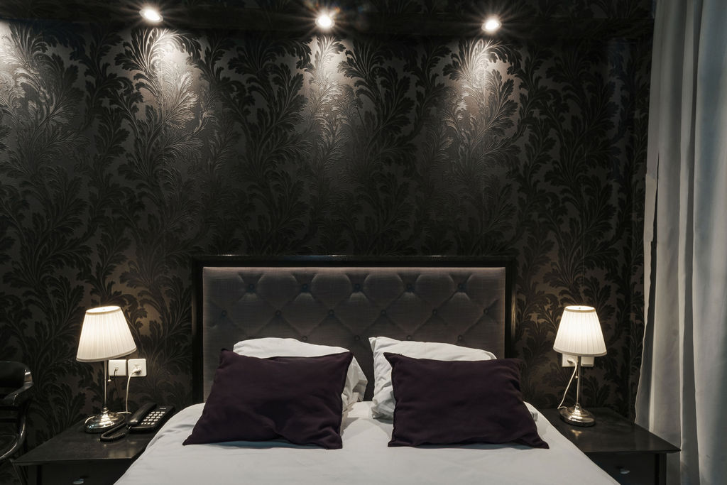 Tête de lit capitonnée et lampes de chevet à l'Hotel Kikar Netanya